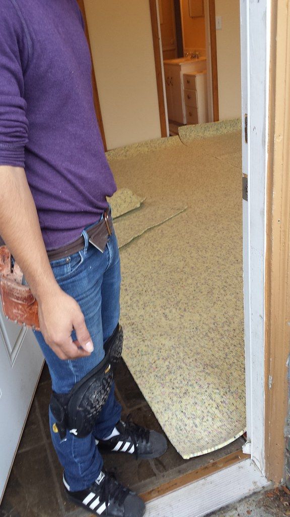 Carpet pulled back from a doorway during a repair